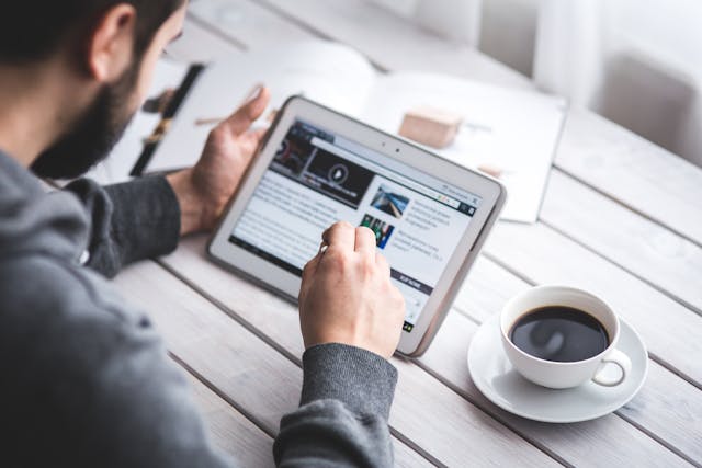a man with an ipad downloading content.