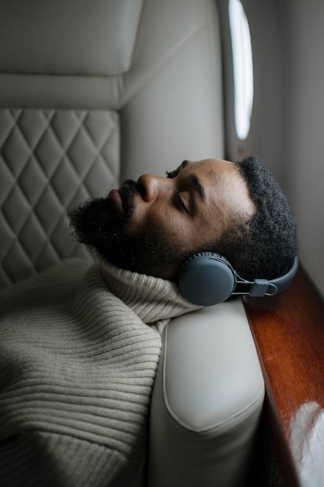 man sleeping on flight